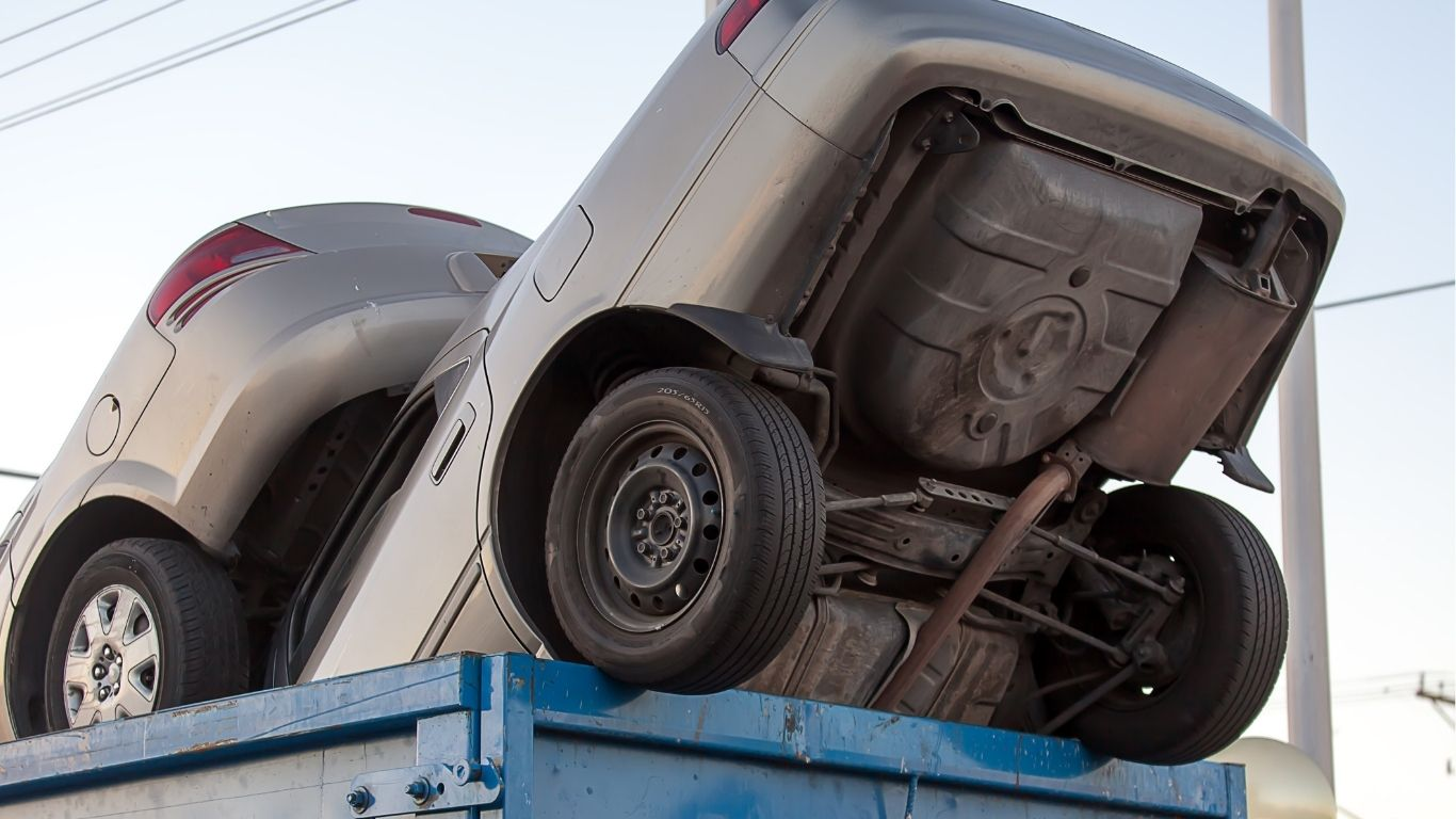 wracked cars in dumpster